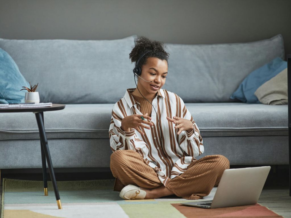 Black woman attending a coaching session on her computer