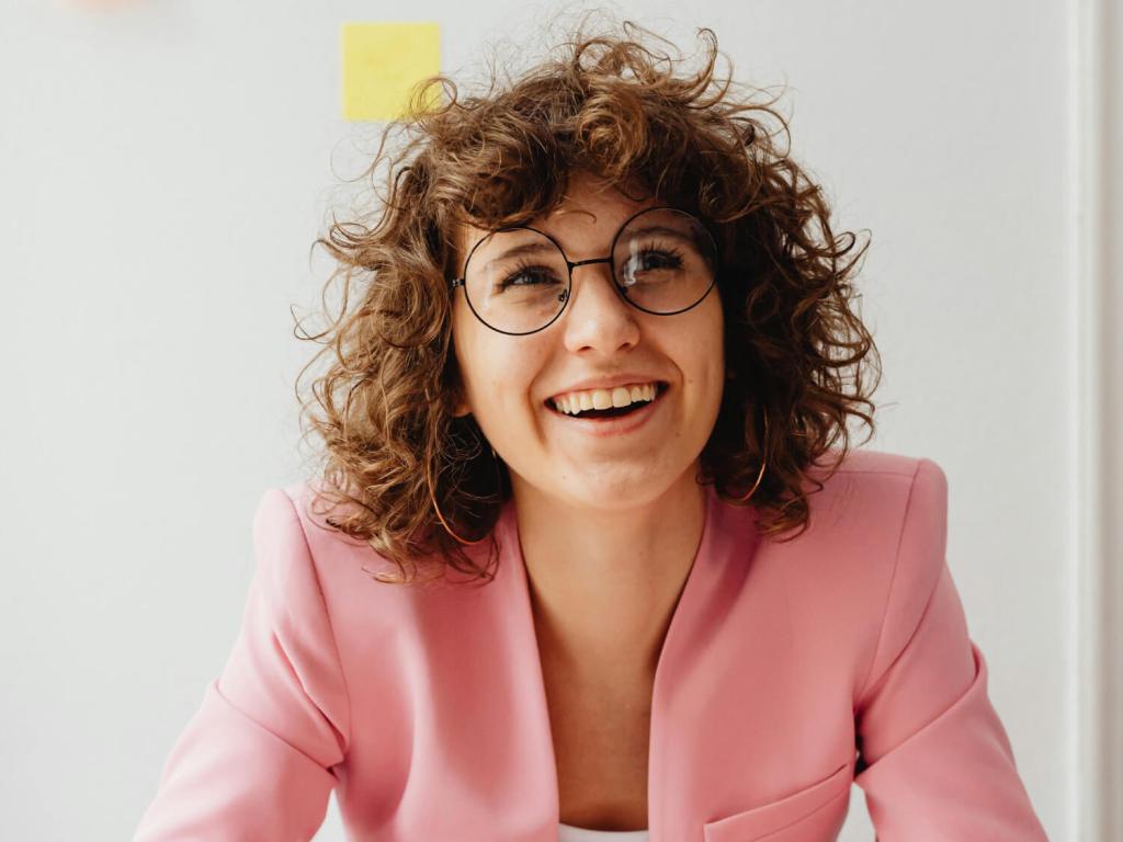 Woman with pink suit smiling